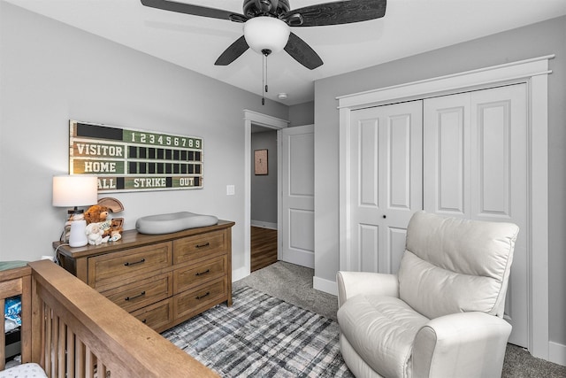 bedroom featuring a closet, dark colored carpet, and ceiling fan