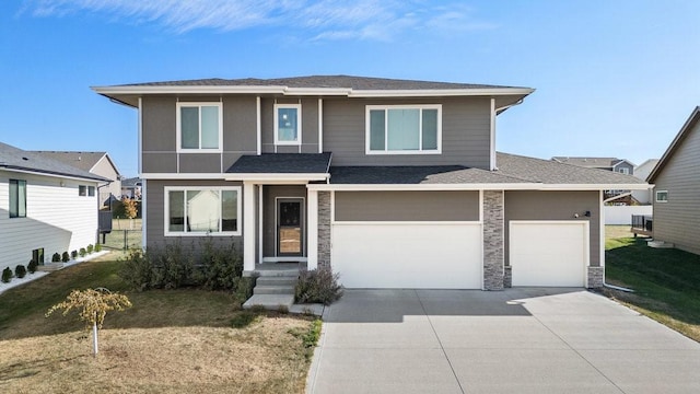 prairie-style home with a front yard and a garage