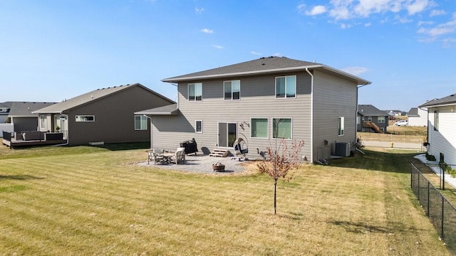 rear view of property featuring a patio area, a yard, and central air condition unit