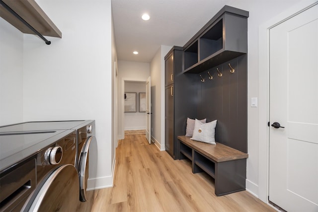 washroom with laundry area, baseboards, recessed lighting, washer and clothes dryer, and light wood-style flooring