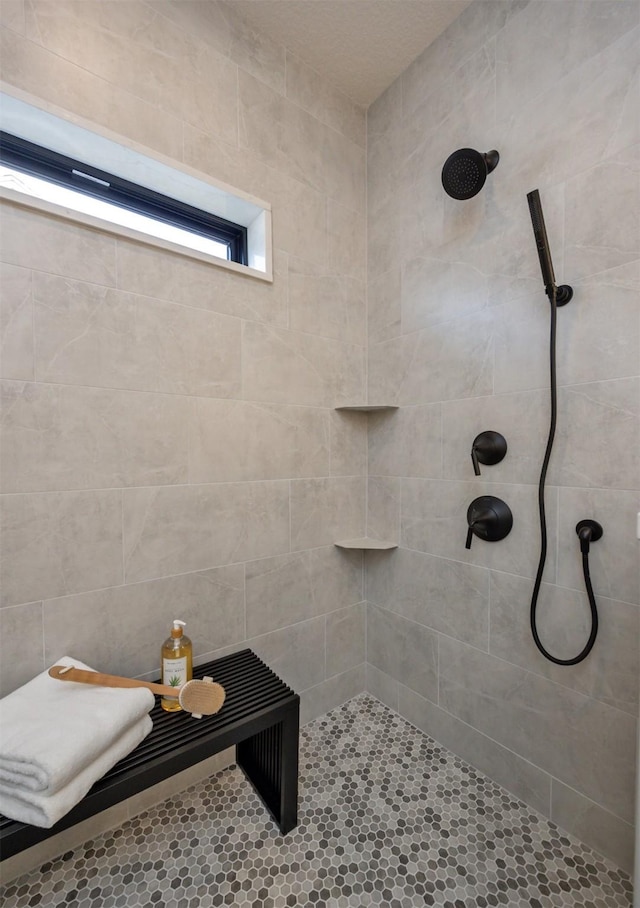 full bath featuring a tile shower
