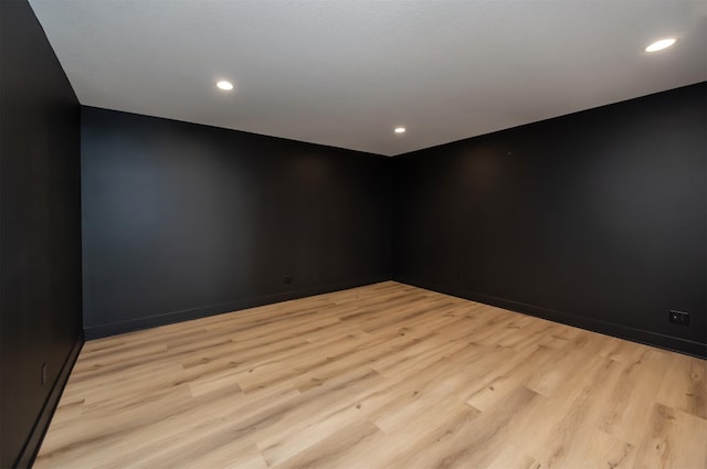 unfurnished room with recessed lighting, baseboards, and light wood finished floors