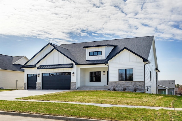 modern farmhouse featuring board and batten siding, a garage, stone siding, and a front lawn