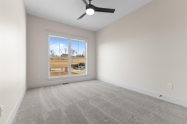 empty room with ceiling fan and carpet floors