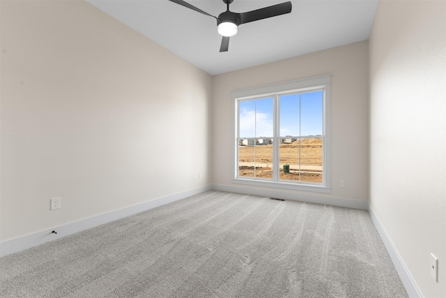 carpeted spare room with ceiling fan