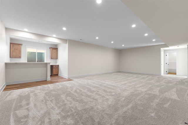 unfurnished living room featuring light carpet