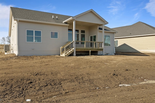 rear view of property with cooling unit and a deck