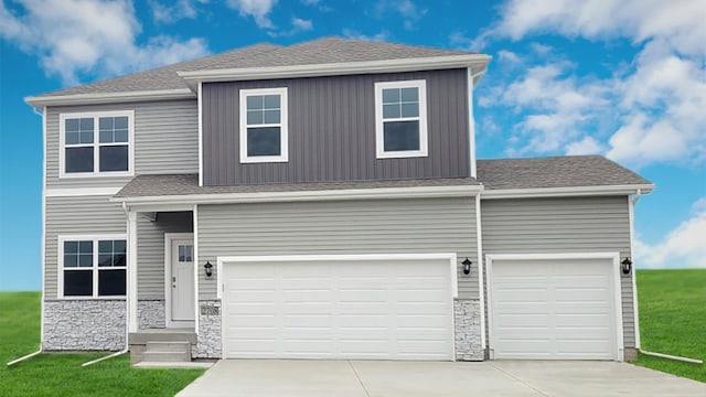 view of front of house featuring a garage and a front yard