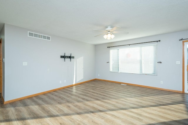 empty room featuring ceiling fan and light wood-type flooring