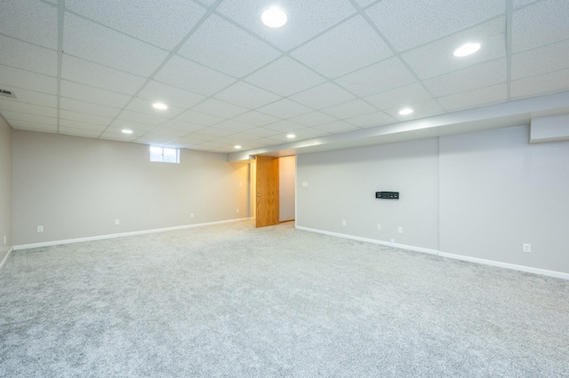 basement featuring recessed lighting, carpet, baseboards, and a paneled ceiling