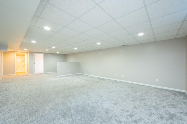 basement with carpet flooring and a drop ceiling