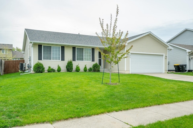 ranch-style home with fence, a garage, a front yard, concrete driveway, and cooling unit