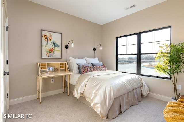 bedroom featuring light colored carpet