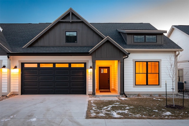 view of front of house featuring a garage and central AC