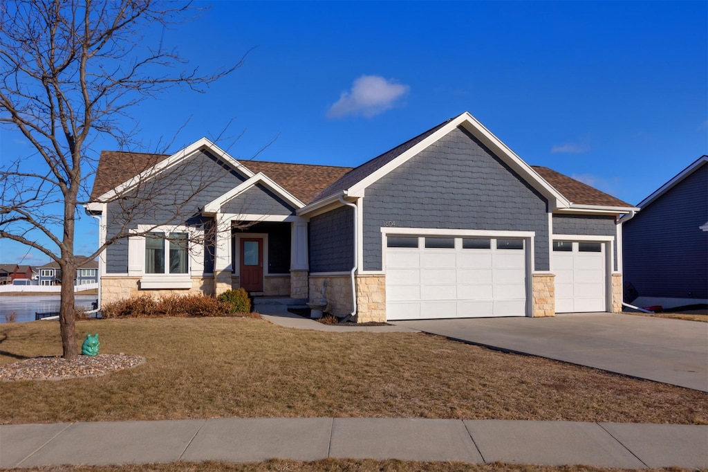 craftsman-style house with a front yard and a garage