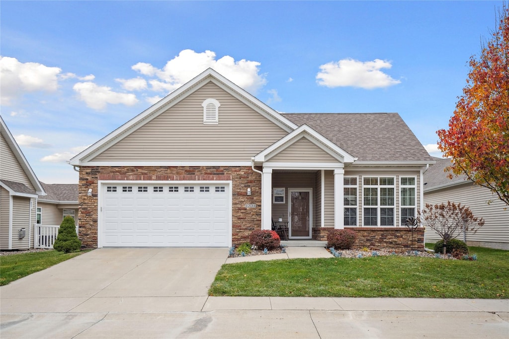 craftsman-style house with a front lawn and a garage