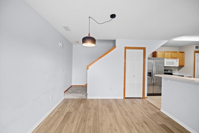 unfurnished living room featuring light wood-type flooring