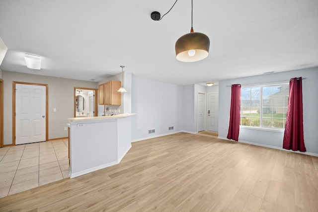 unfurnished living room featuring light wood-type flooring