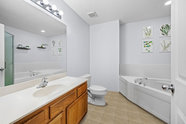 bathroom with toilet, vanity, a bathing tub, and tile patterned flooring