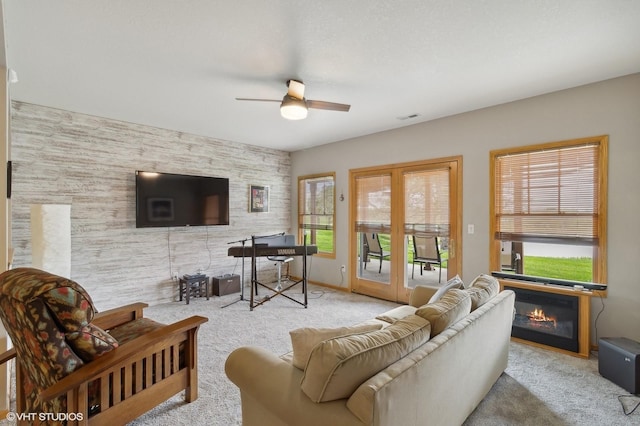 carpeted living room featuring ceiling fan