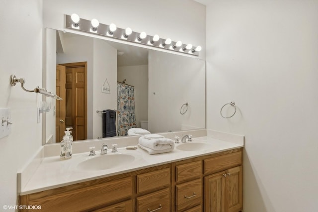 bathroom with toilet, vanity, and walk in shower