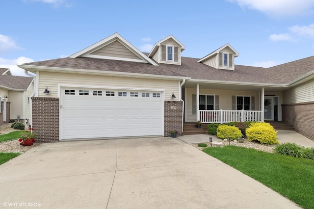 view of front of property with covered porch and a garage