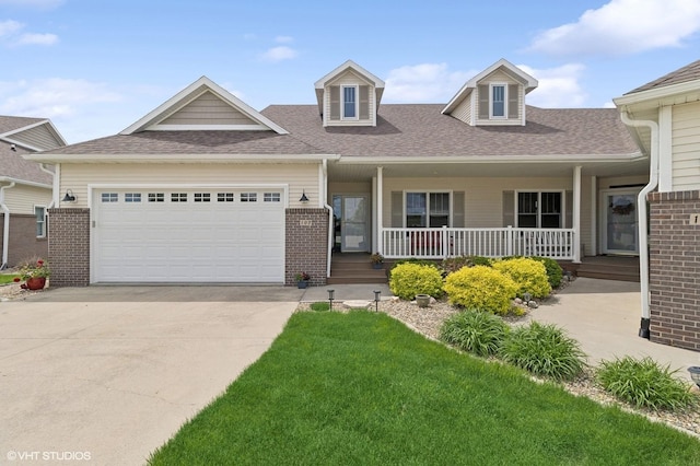 view of front of home featuring a garage, a front yard, and a porch