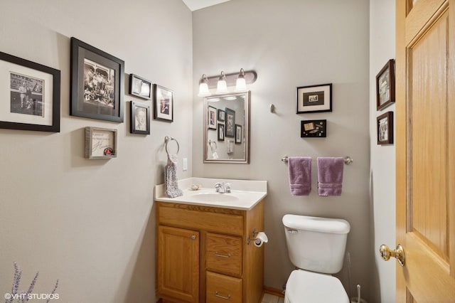 bathroom featuring toilet and vanity