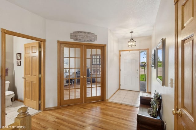 entrance foyer featuring french doors and light hardwood / wood-style floors