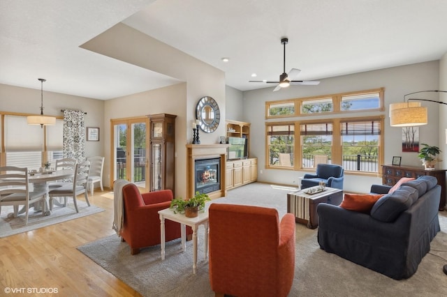 living room featuring ceiling fan and light hardwood / wood-style flooring