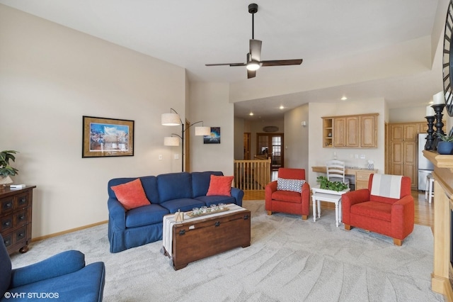 carpeted living room featuring ceiling fan