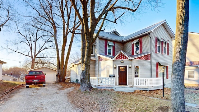 view of front of home with a garage, an outdoor structure, and a porch