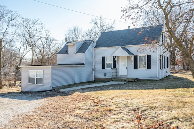 new england style home with a front lawn