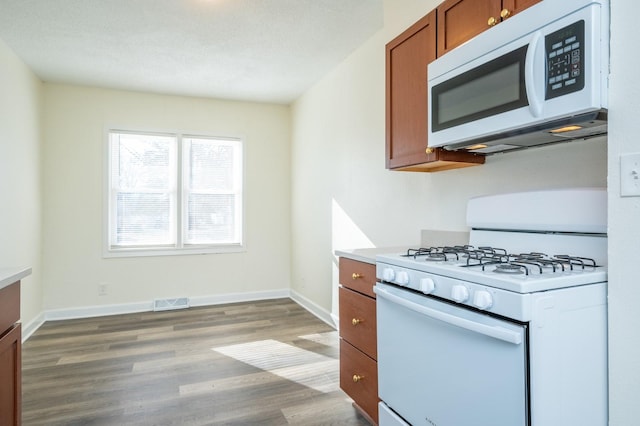 kitchen featuring white appliances and light wood-type flooring