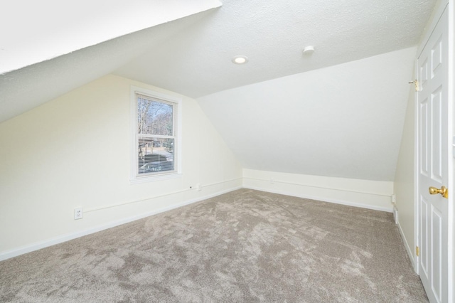 bonus room featuring carpet floors, a textured ceiling, and vaulted ceiling