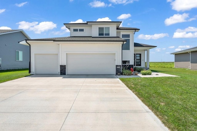 view of front of house featuring a garage and a front lawn