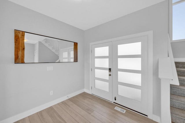 foyer entrance with french doors and light wood-type flooring