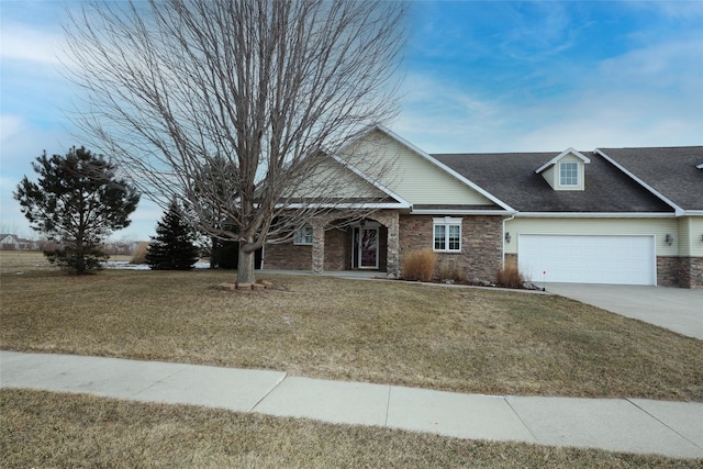 view of front of home featuring a front yard and a garage