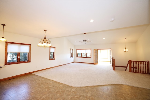 unfurnished room with ceiling fan with notable chandelier