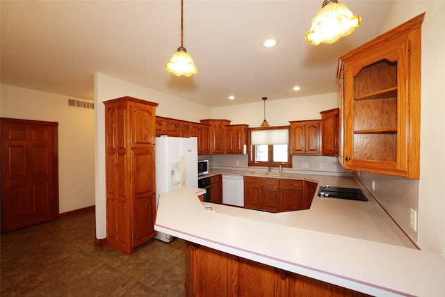 kitchen featuring decorative light fixtures, sink, white appliances, and kitchen peninsula