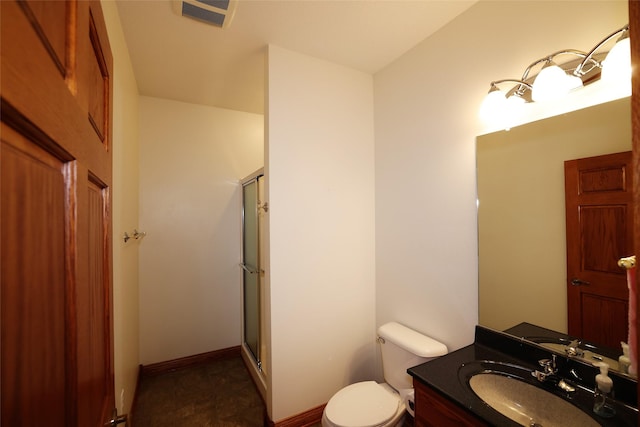 bathroom featuring walk in shower, vanity, and toilet