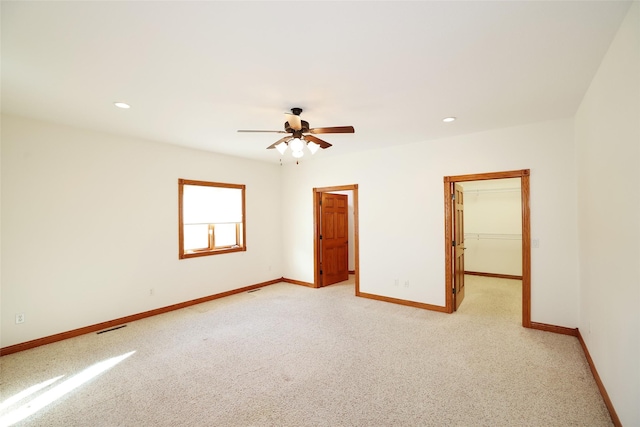 empty room with light carpet and ceiling fan