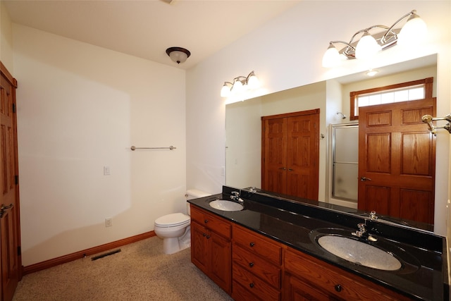 bathroom featuring toilet, walk in shower, and vanity