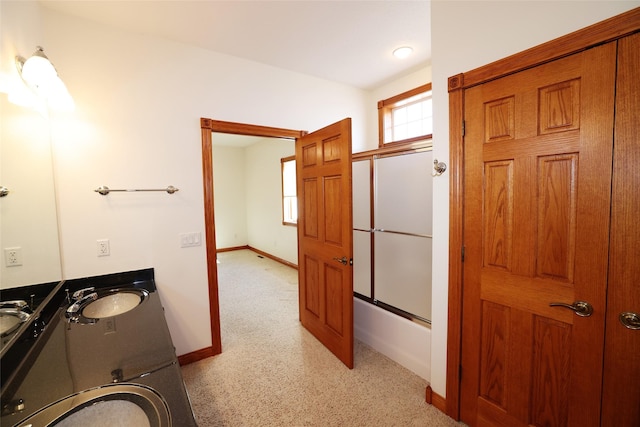 bathroom featuring vanity and shower / bath combination with glass door