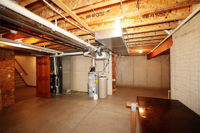 basement featuring brick wall, heating unit, and gas water heater