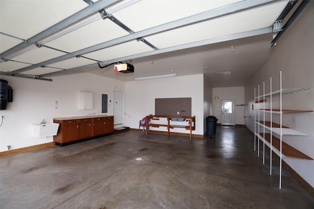 garage with a garage door opener, sink, and electric panel