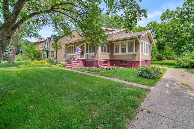 1001 42nd St, Des Moines, IA 50311 - view of front of home with a front yard, brick siding, and asphalt driveway