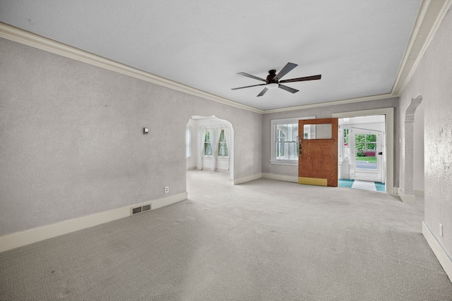 1001 42nd St, Des Moines, IA 50311 - empty room with ornamental molding, arched walkways, ceiling fan, carpet flooring, and baseboards