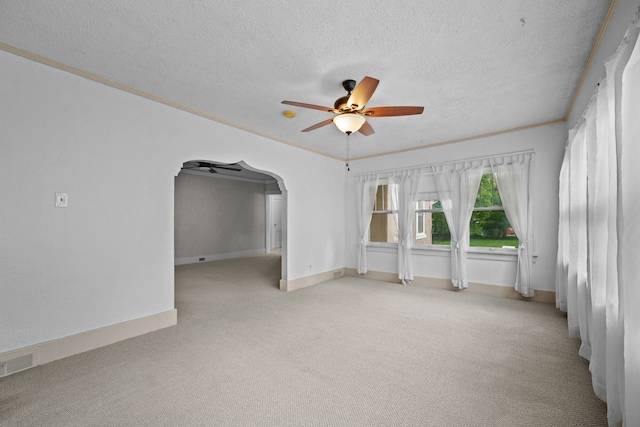 1001 42nd St, Des Moines, IA 50311 - unfurnished room with a ceiling fan, carpet floors, a textured ceiling, arched walkways, and ornamental molding