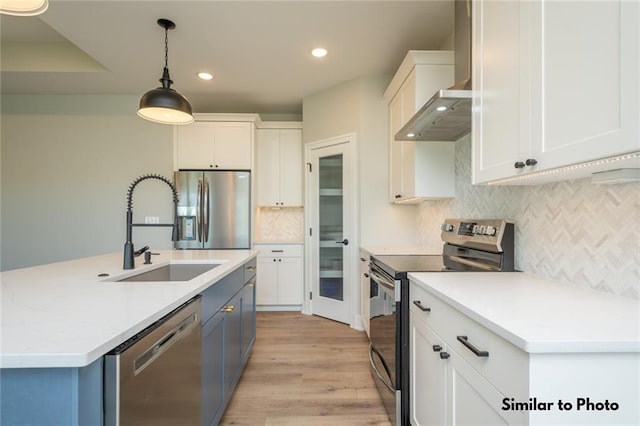 kitchen featuring sink, pendant lighting, appliances with stainless steel finishes, and white cabinets